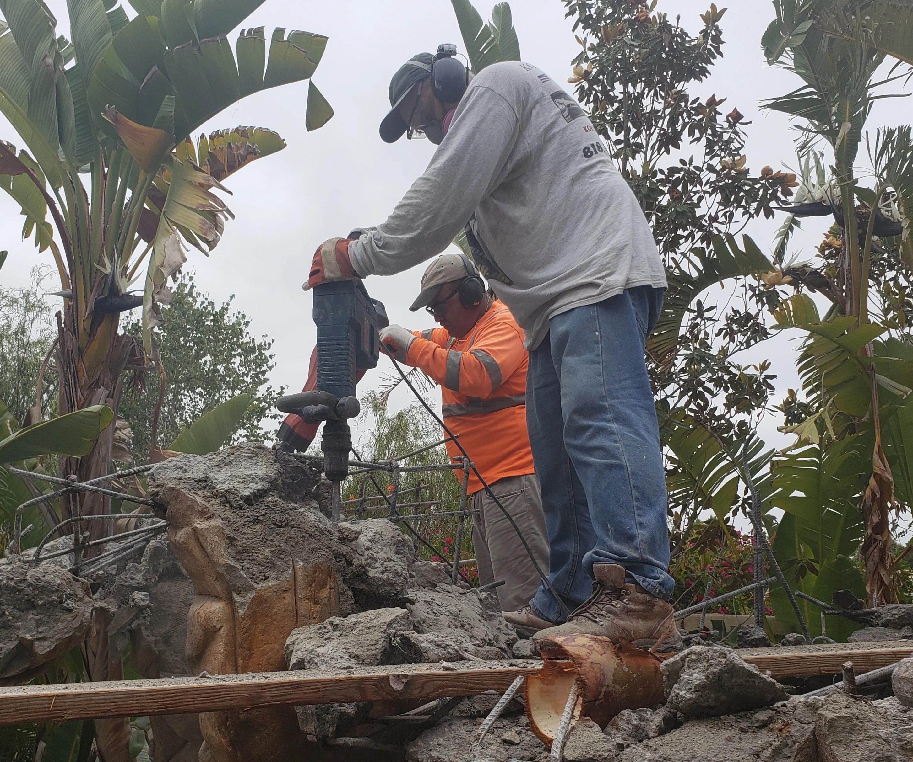 Licensed concrete removal crew using jackhammer